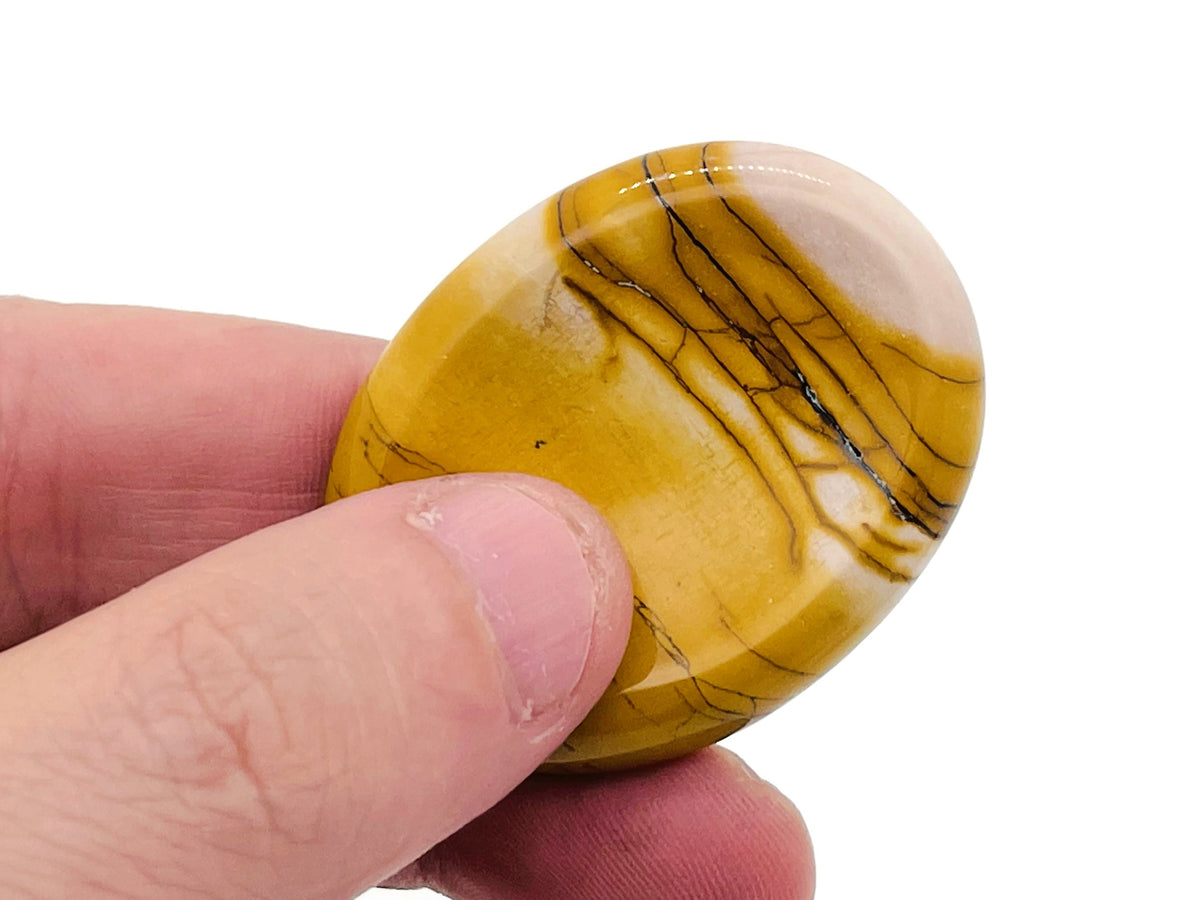 Smooth crystal worry stone from GemstoneGO, measuring 45x35mm, used for stress relief and soothing tactile stress management.