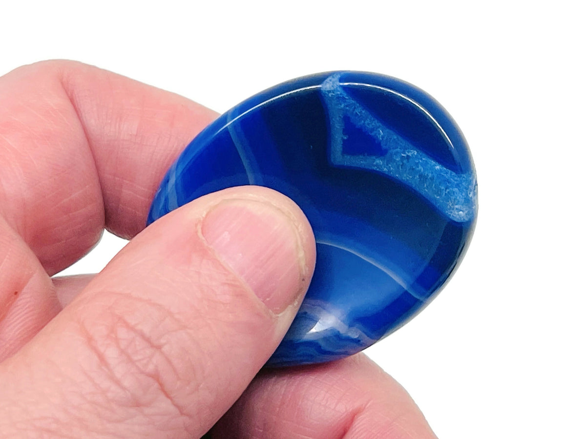Smooth crystal worry stone from GemstoneGO, 45x35mm, featuring calming colors and polished surface for stress relief and relaxation.