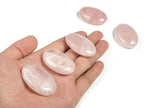 Rose quartz palm gemstone spa stone, 45x35mm, smooth polished healing crystal from GemstoneGO, used for relaxation and energy balancing.