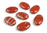 Red Jasper palm gemstone spa stone, 45x35mm, from GemstoneGO, showing polished surface and natural red stone texture.