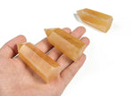 Orange Calcite obelisk tower crystal from GemstoneGO, showcasing a vibrant orange mineral with natural striations and polished finish.