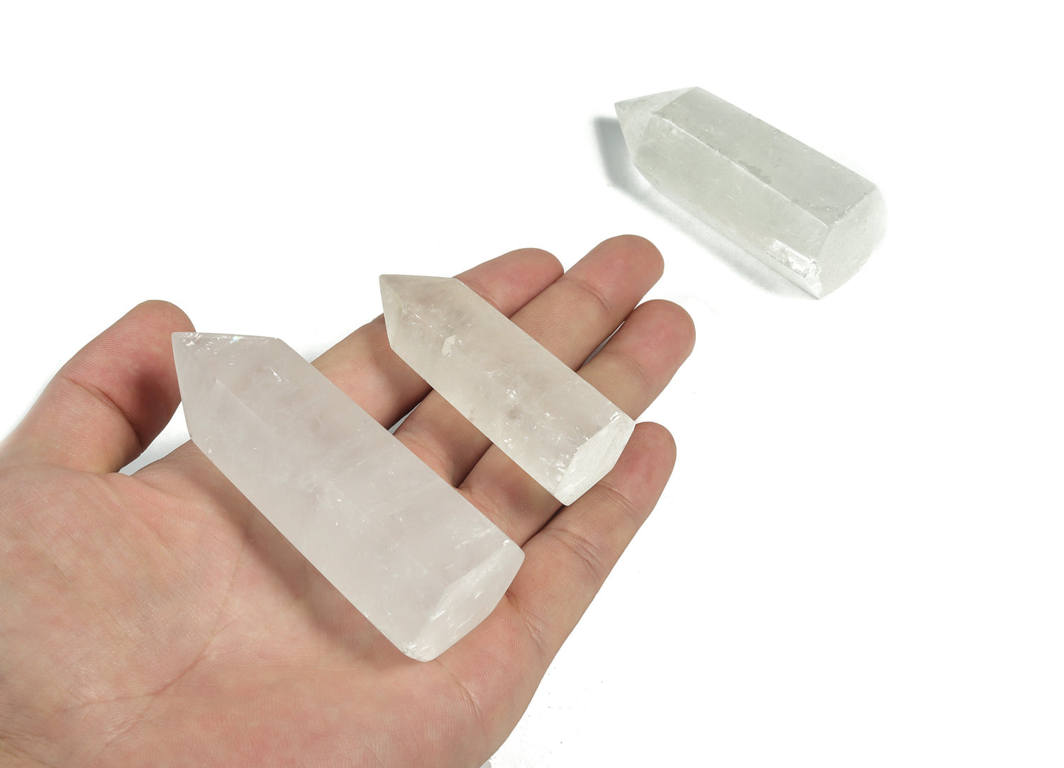 Snow Quartz obelisk tower crystal from GemstoneGO, showing a polished white quartz obelisk with natural crystal patterns.