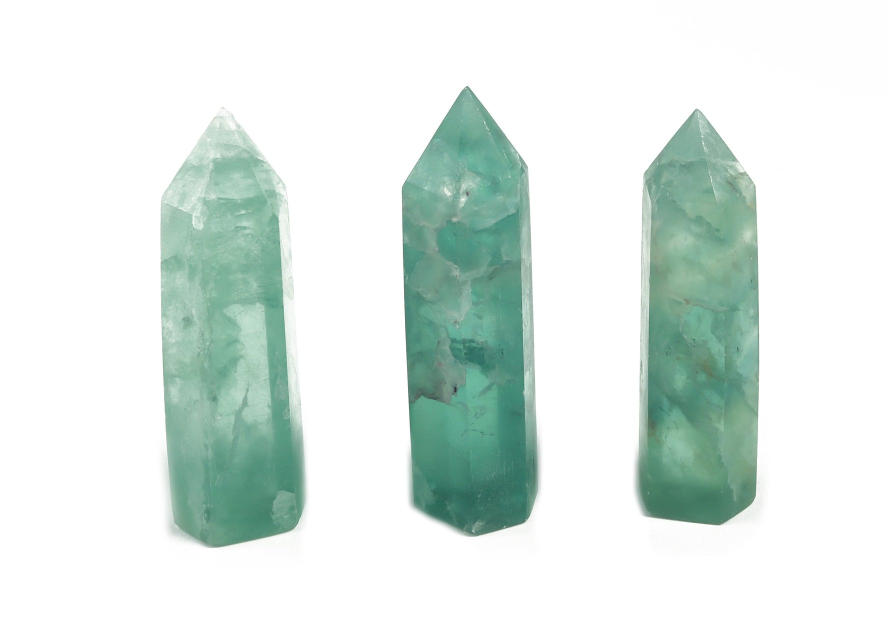 Green fluorite obelisk tower crystal from GemstoneGO, showcasing a polished green gemstone with a pointed tip and smooth surfaces.