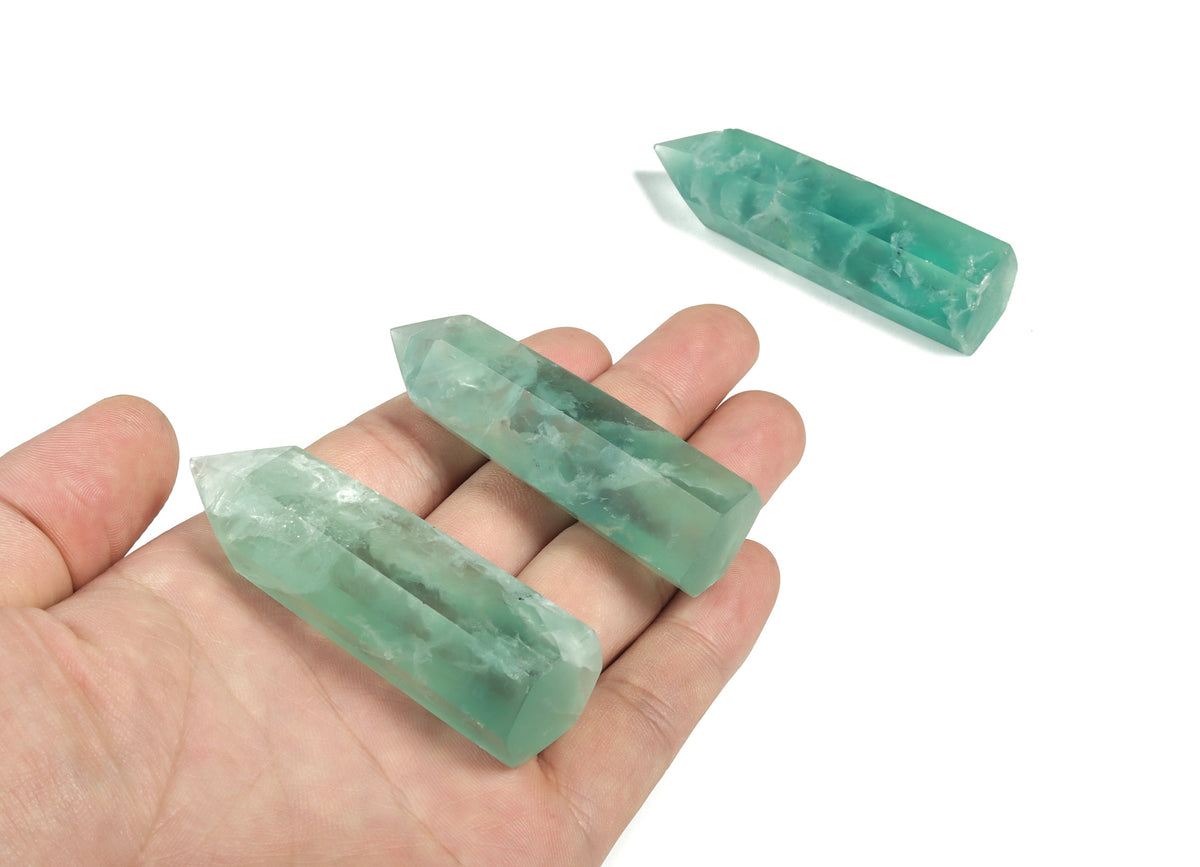 Green fluorite obelisk tower crystal from GemstoneGO with vibrant green hues and polished, pointed design.