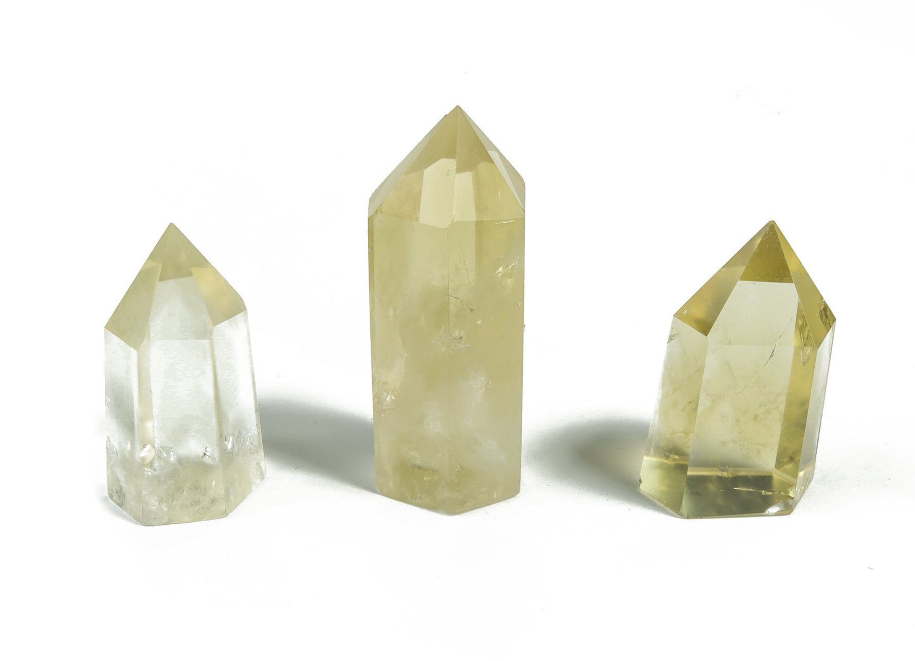 Citrine obelisk tower crystal from GemstoneGO, showing a golden-yellow gemstone with a pointed top and smooth polished surface.