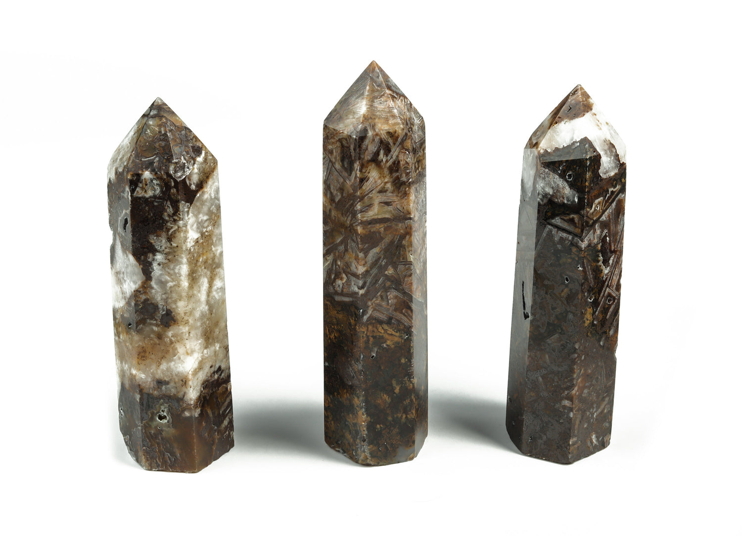 Ribbed obelisk tower crystal in clear gemstone with textured ribbed surface, displayed on a plain background.