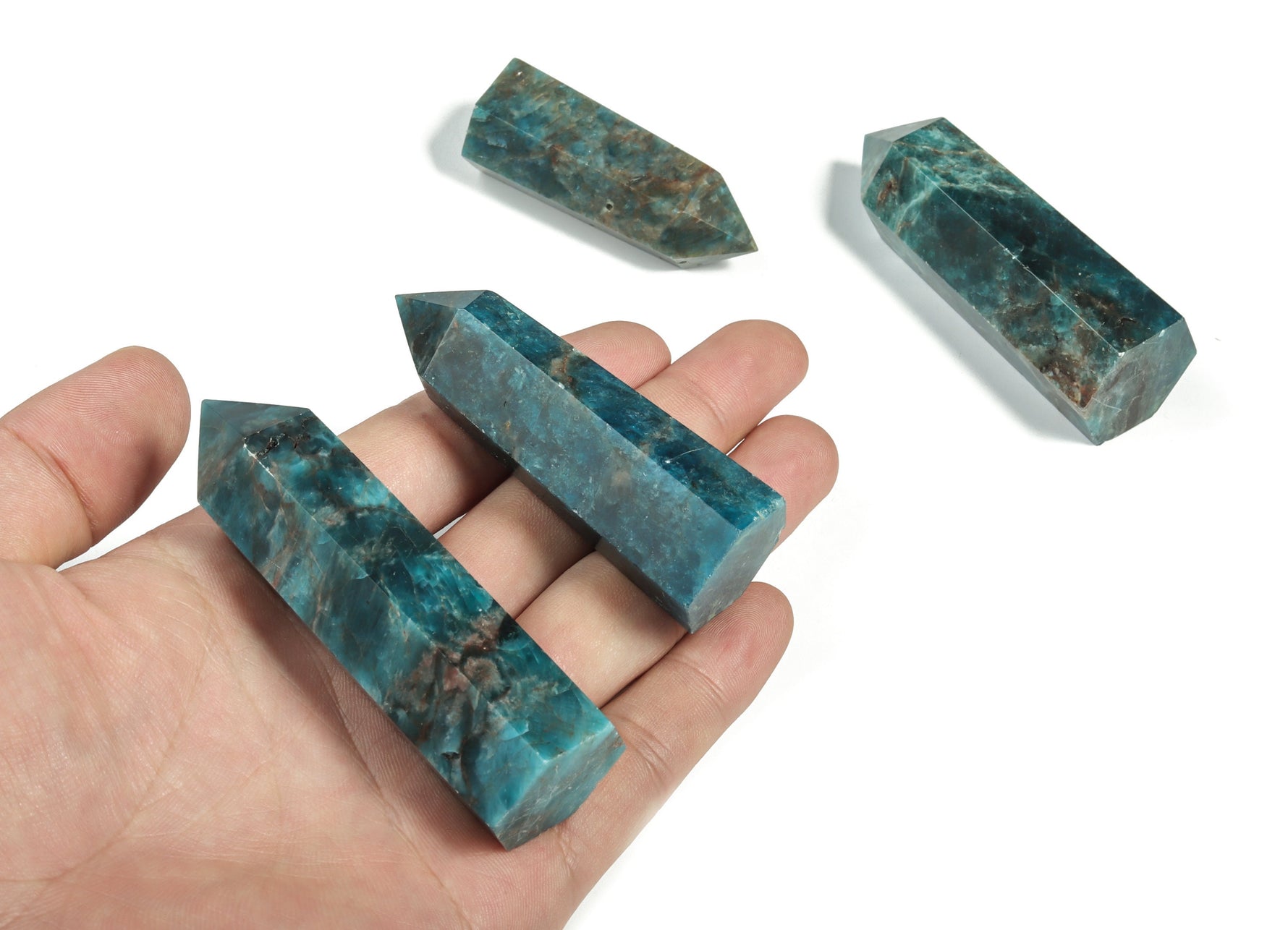 Blue Apatite Quartz obelisk tower crystal by GemstoneGO showing a polished blue crystal point with natural striations and a pointed tip.