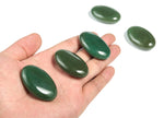 Aventurine palm gemstone spa stone, 45x35mm, showcasing green and shimmering mineral details, used for relaxation and massage.
