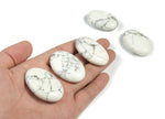 Howlite palm gemstone spa stone, 45x35mm, from GemstoneGO, showcasing a smooth, polished white and gray patterned healing stone.