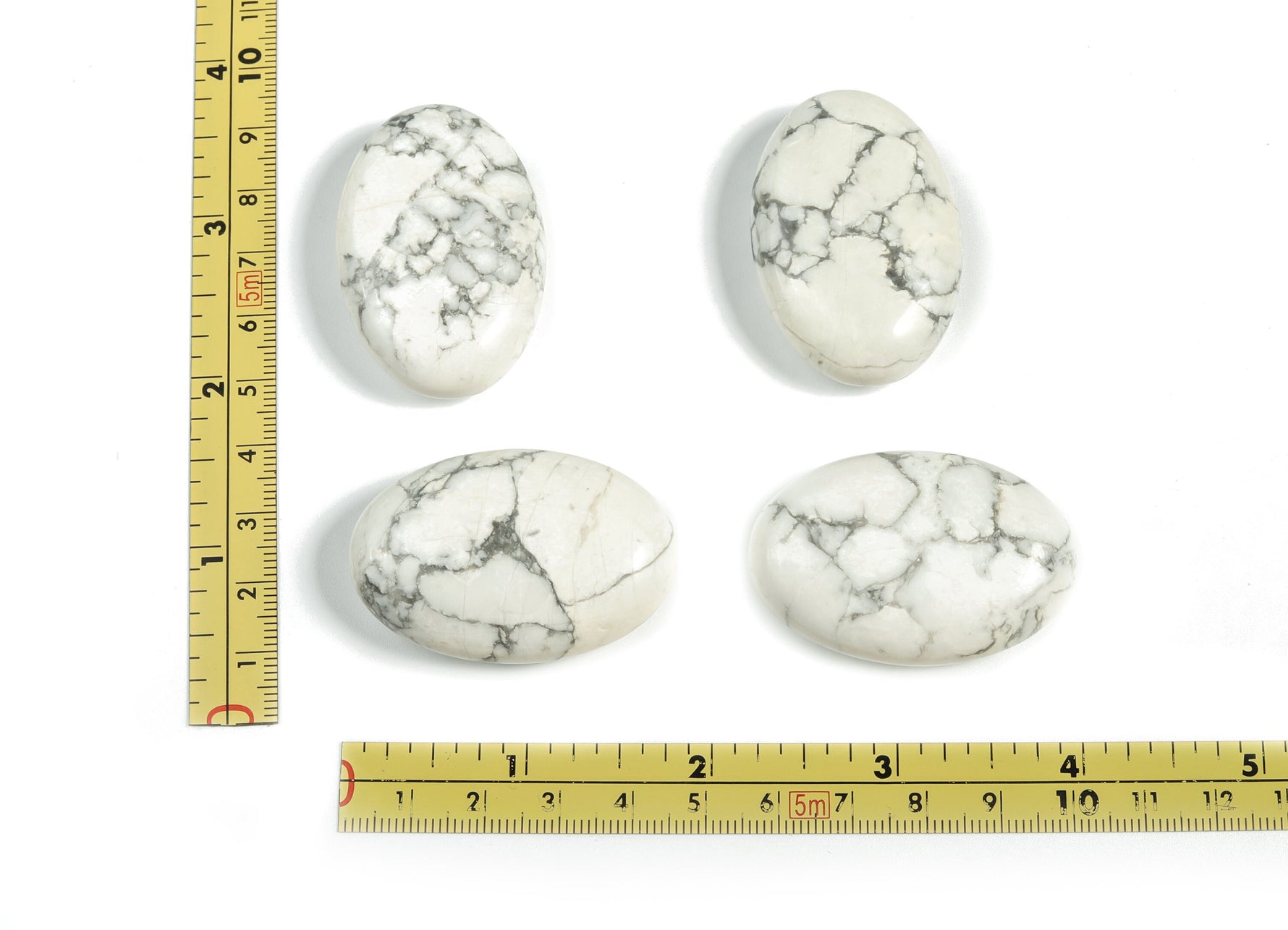 Howlite palm gemstone spa stone, 45x35mm, smooth white and grey mineral healing stone for relaxation and massage.