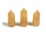 Orange Calcite obelisk tower crystal from GemstoneGO, showcasing vibrant orange color and smooth polished surface.