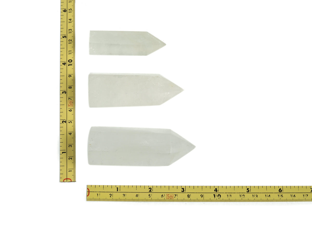 Snow Quartz obelisk tower crystal from GemstoneGO featuring a smooth, polished white gemstone obelisk with natural crystal patterns.