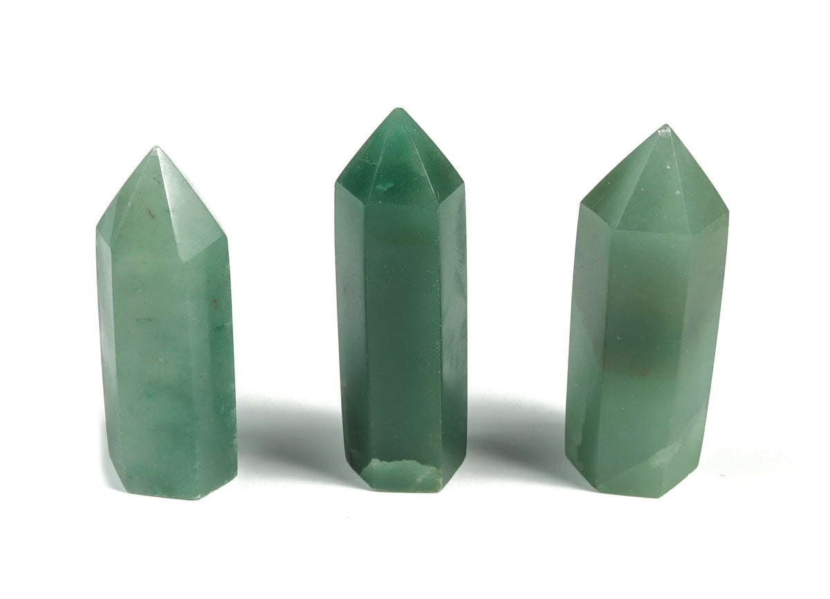Aventurine obelisk tower crystal from GemstoneGO showcasing a green gemstone with natural striations and polished surfaces.