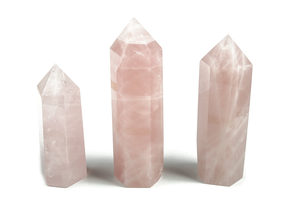 Rose Quartz obelisk tower crystal from GemstoneGO, showcasing a pink, polished gemstone with a pointed top and smooth sides.