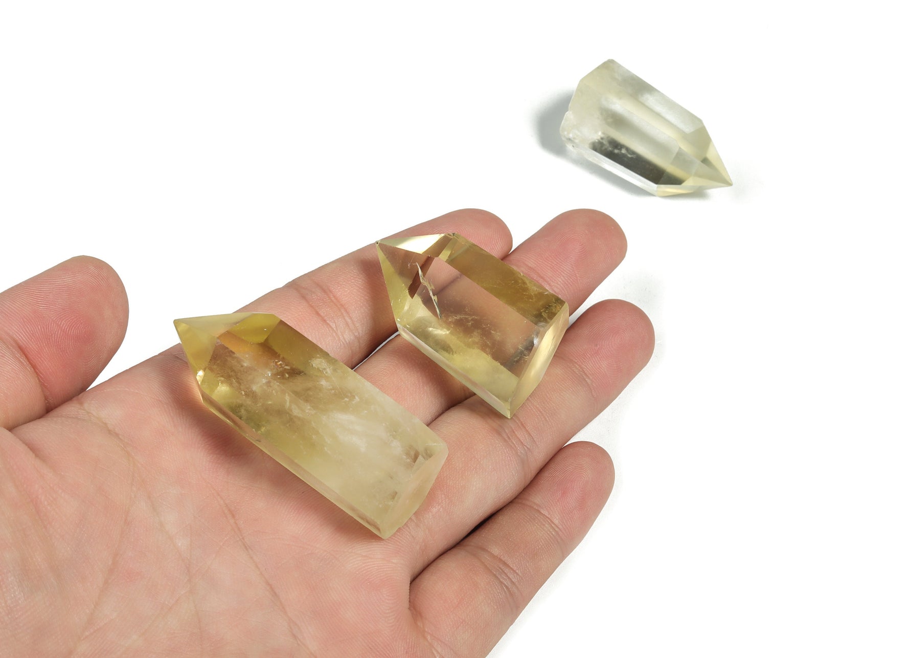 Citrine Obelisk Tower crystal from GemstoneGO with a vibrant orange-yellow hue and pointed geometric shape.