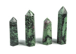 Ruby Zoisite obelisk tower crystal from GemstoneGO, featuring vibrant red and green mineral patterns on a polished stone.