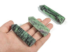 Ruby Zoisite obelisk tower crystal from GemstoneGO, showcasing a vibrant, polished gemstone with rich red and green mineral patterns.