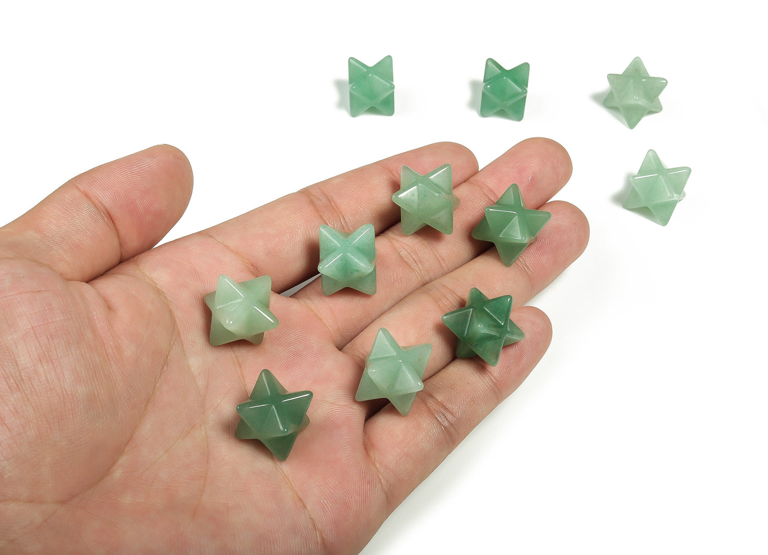 A 13mm Aventurine Merkaba star crystal from GemstoneGO, showcasing a green, polished gemstone with intricate star shape design.