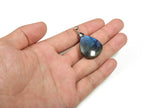 Labradorite crystal pendant from GemstoneGO for jewelry making, showcasing iridescent gray-blue stone with natural flash and smooth surface.