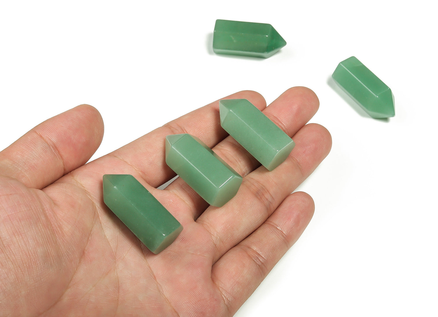Aventurine obelisk tower crystal from GemstoneGO, 35mm, showcasing green and gold mineral patterns on a clear background.