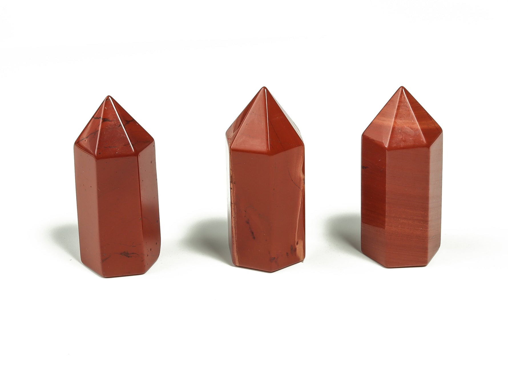 Red Jasper obelisk tower crystal, 35mm, from GemstoneGO, showcasing its deep red color and polished pointed shape.