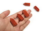 Red Jasper obelisk tower crystal from GemstoneGO, 35mm tall, showcasing a vibrant red stone with natural striations and a pointed tip.