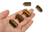 Tiger Eye obelisk tower crystal, 35mm, from GemstoneGO, showcasing its polished, golden-brown stone with natural striations and shine.