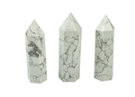 Howlite obelisk tower crystal by GemstoneGO, showcasing a white and gray marbled stone with a pointed tip and smooth polished surface.
