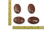 Red sesame jasper palm gemstone spa stone, 45x35mm, polished smooth red and brown gemstone, used for massage and relaxation.
