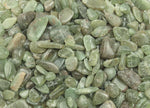Green Apatite crystal chips, semi-tumbled gemstones in 7-12mm, from GemstoneGO, shown in a natural close-up view.