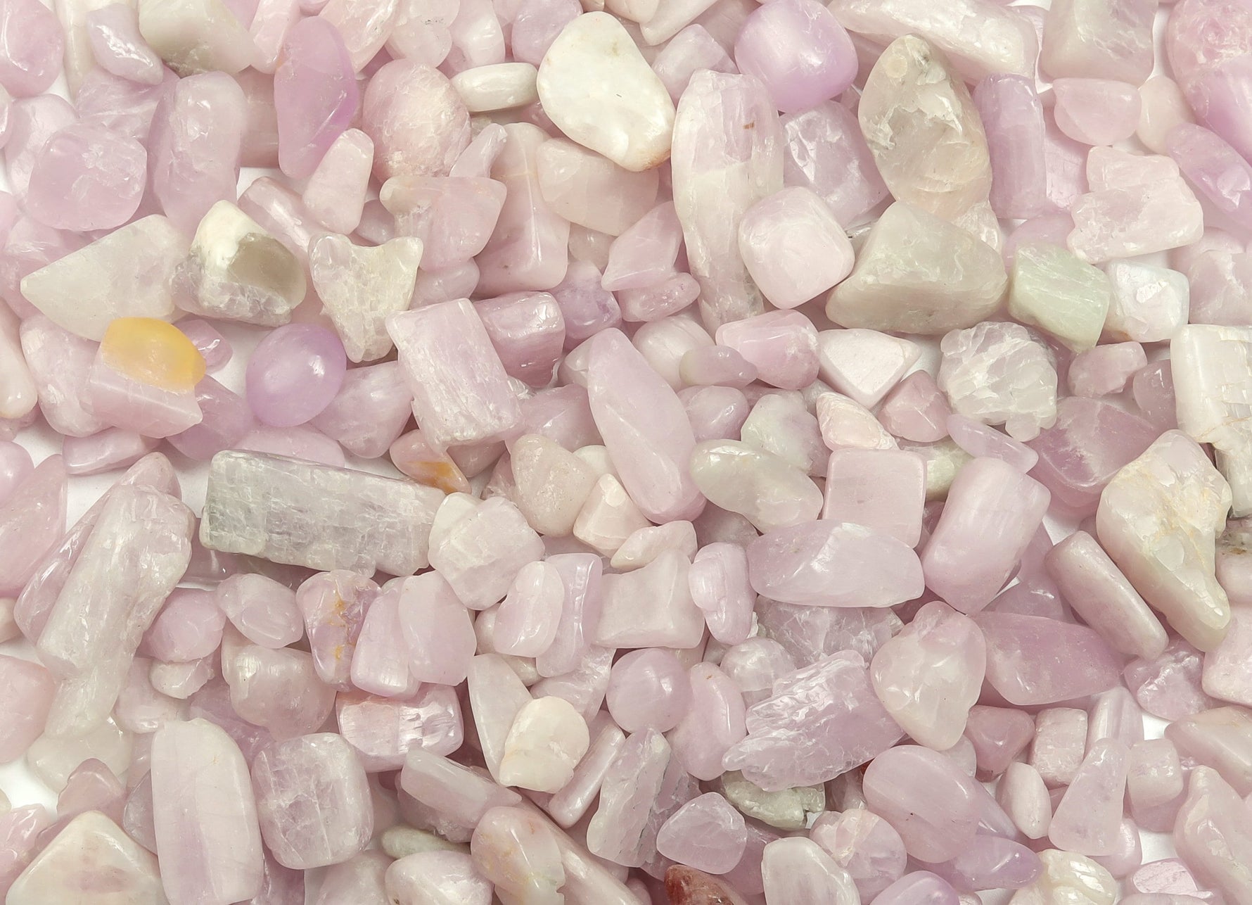 Semi-tumbled kunzite crystal chips in 7-12mm, showcasing pink-purple hues, from GemstoneGO for jewelry and craft projects.