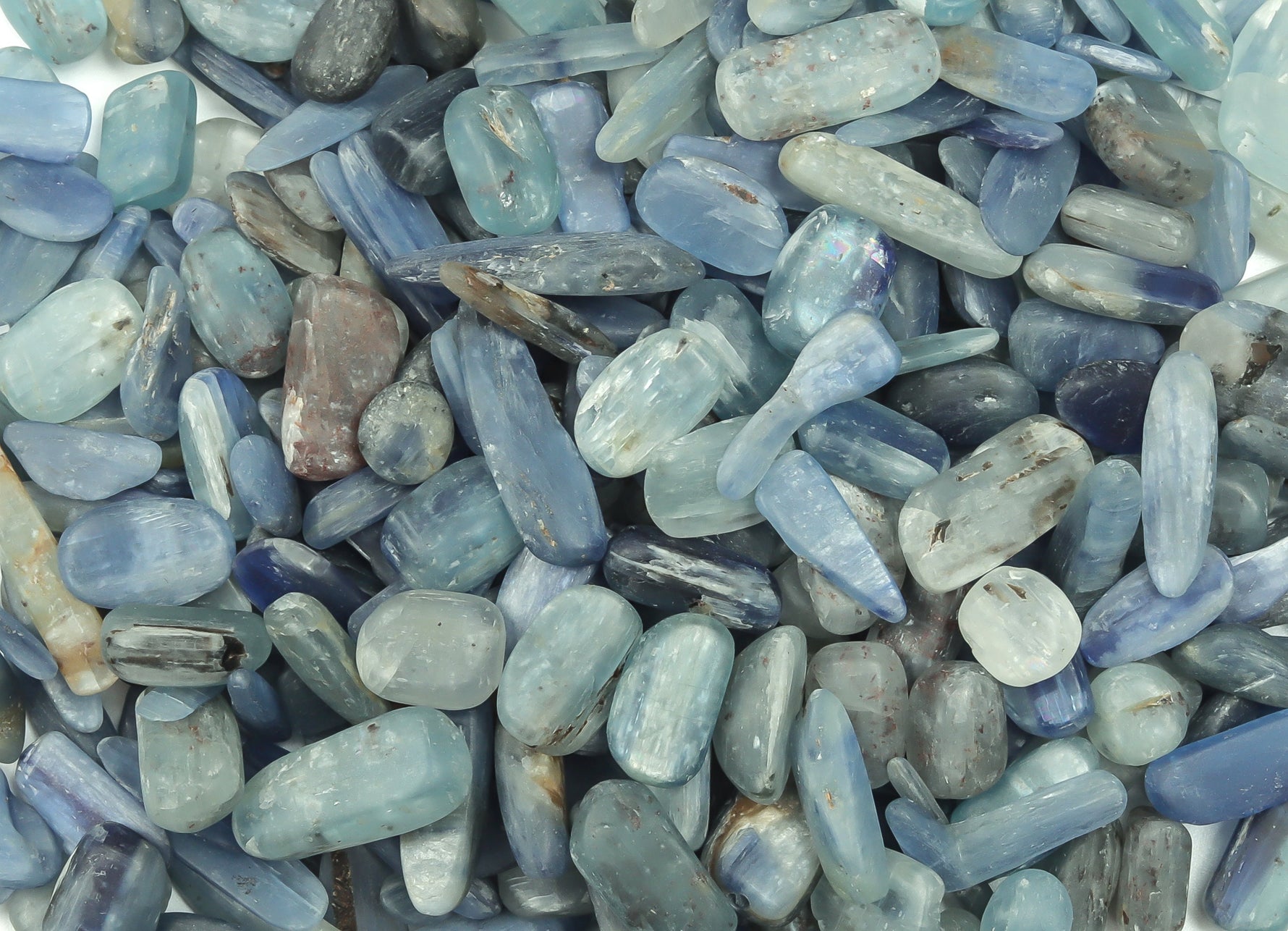 Semi-tumbled Kyanite crystal chips, 7-12mm bulk gemstones from GemstoneGO, showcasing vibrant blue mineral fragments.