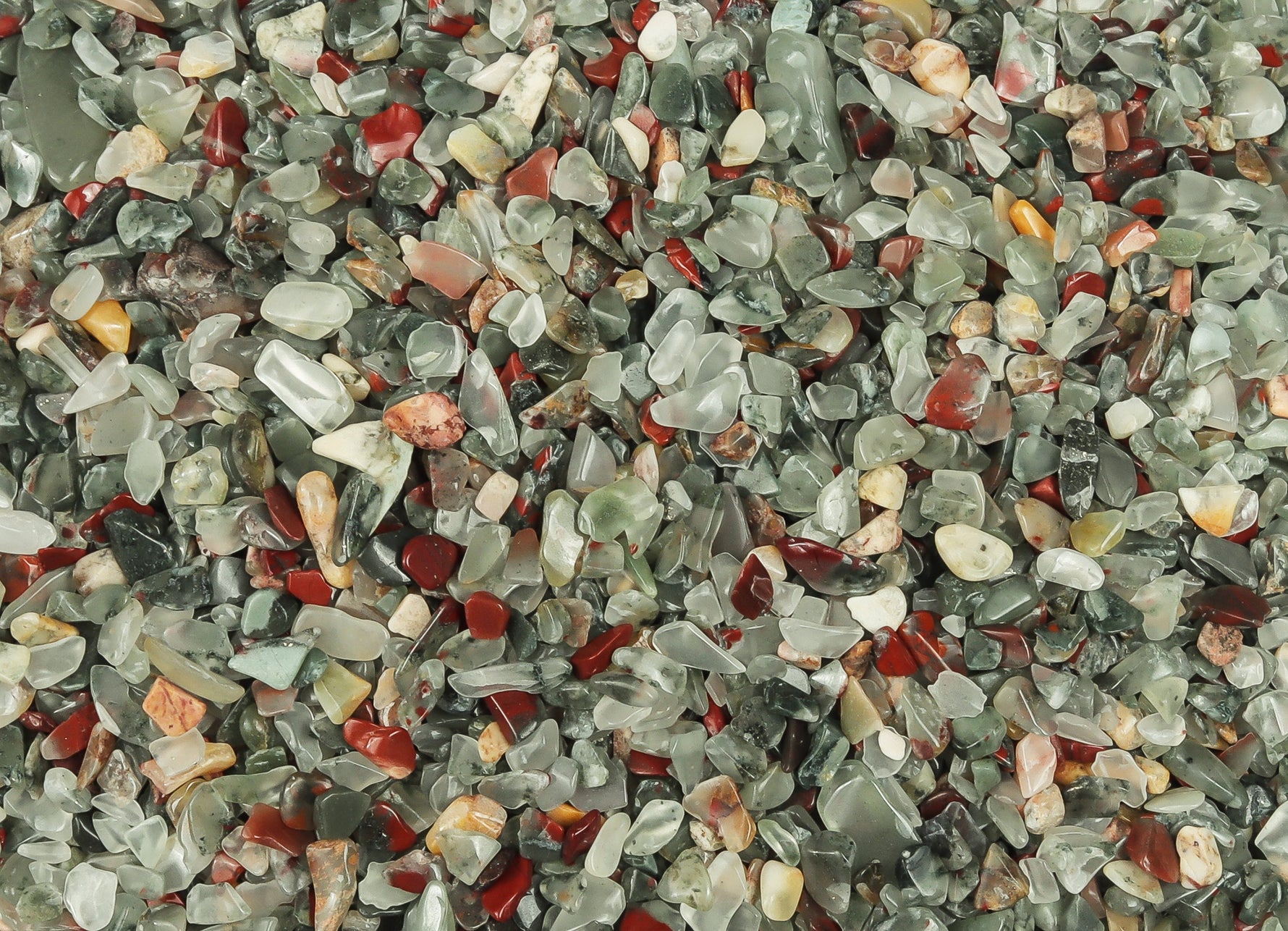 Semi-tumbled African Bloodstone crystal chips in 2-6mm, natural gemstone from GemstoneGO, arranged in a pile.