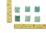 A 13mm Aventurine Merkaba star crystal from GemstoneGO, used for Reiki healing and spiritual meditation.