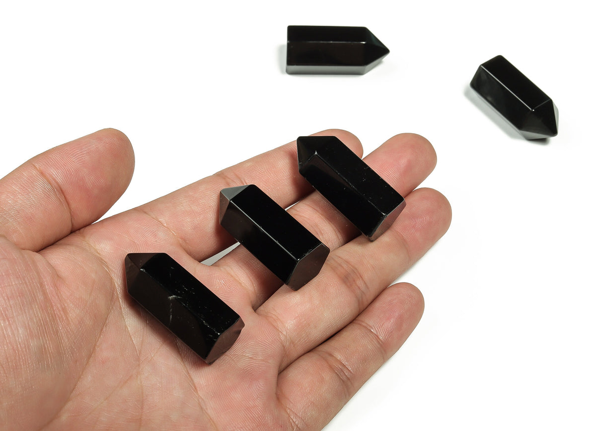 Obsidian Obelisk Tower crystal from GemstoneGO, 35mm tall, with glossy black surface and natural stone details.