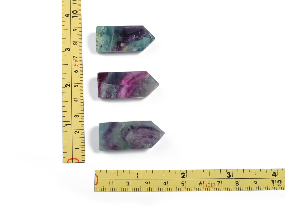 Green fluorite obelisk tower crystal, 35mm, from GemstoneGO, showcasing a polished natural mineral with vibrant green hues.
