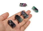 Natural fluorite obelisk tower crystal, 35mm gemstone with vibrant green and purple hues, from GemstoneGO.