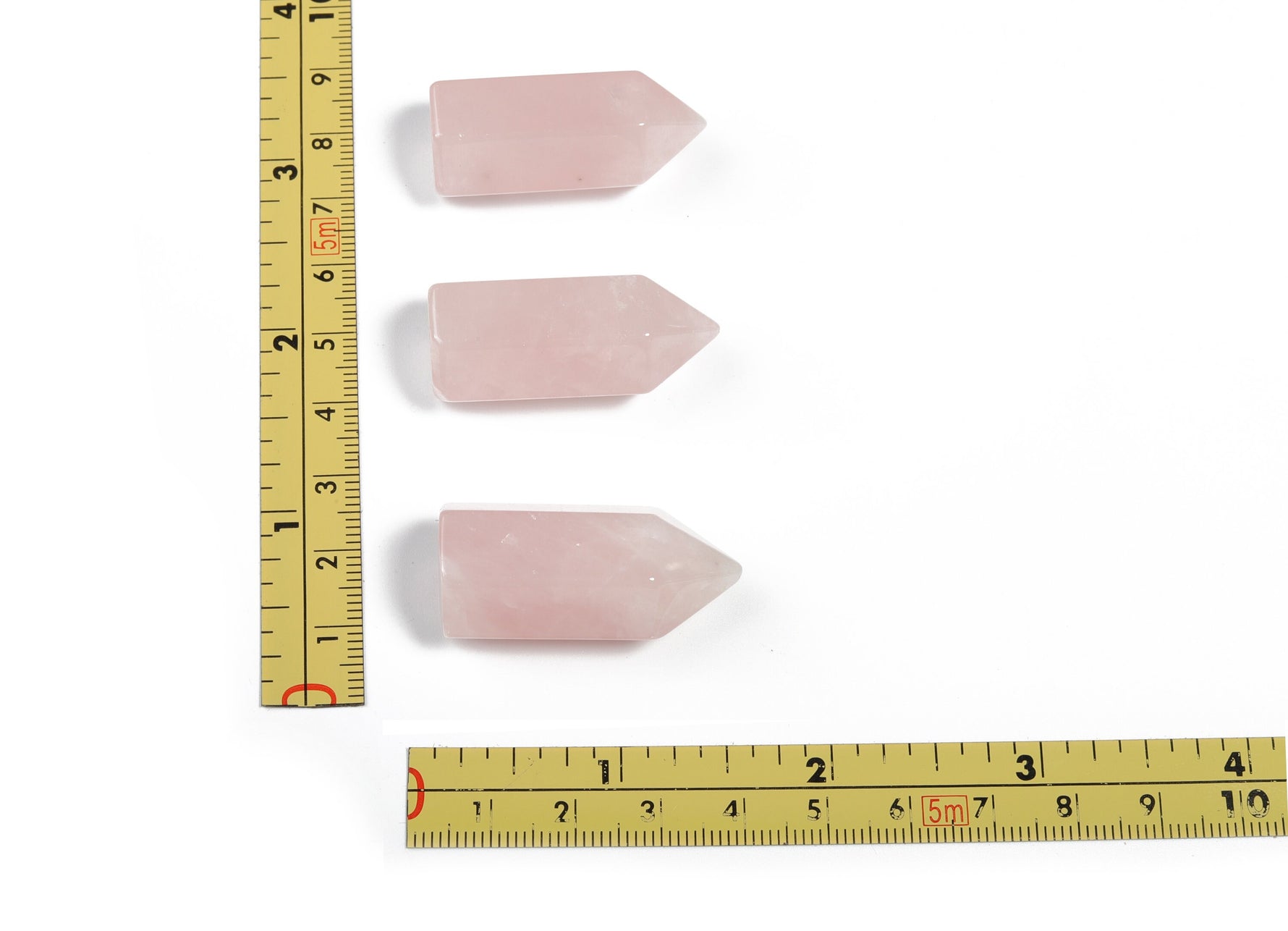 Rose Quartz obelisk tower crystal from GemstoneGO with a polished pink gemstone pointed shape on a neutral background.