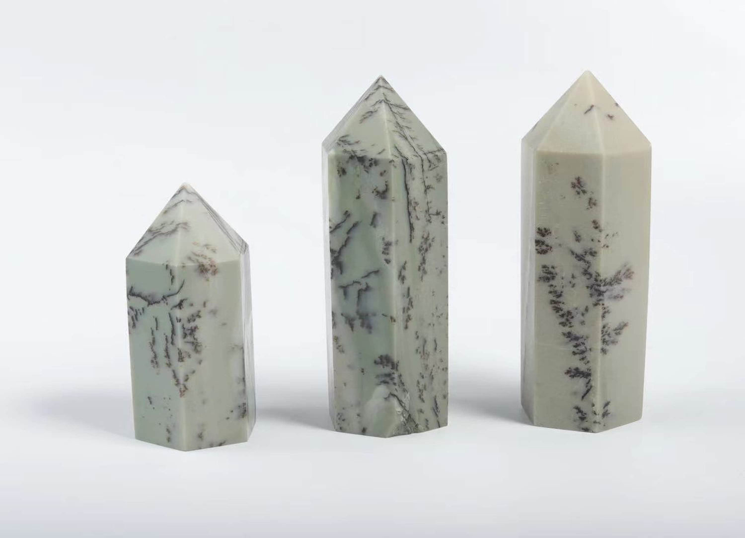 Dendritic Jade obelisk tower crystal from GemstoneGO, showcasing green and brown dendritic patterns on a tall, polished gemstone sculpture.