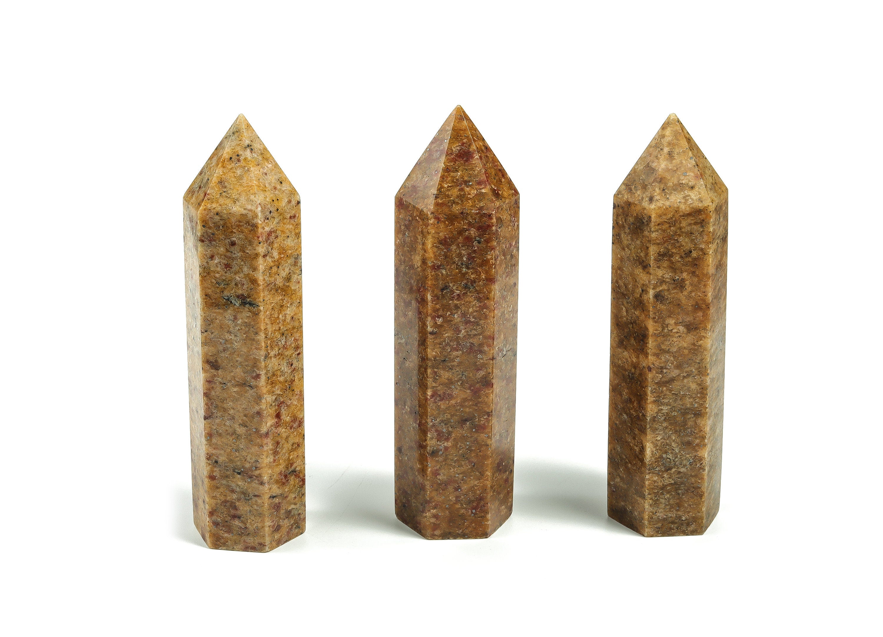 Golden silk jade obelisk tower crystal from GemstoneGO featuring a polished, golden-hued jade gemstone shaped into a tall obelisk.