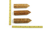 Golden silk jade obelisk tower crystal from GemstoneGO, showcasing a polished, golden-toned jade gemstone with a pointed obelisk shape.