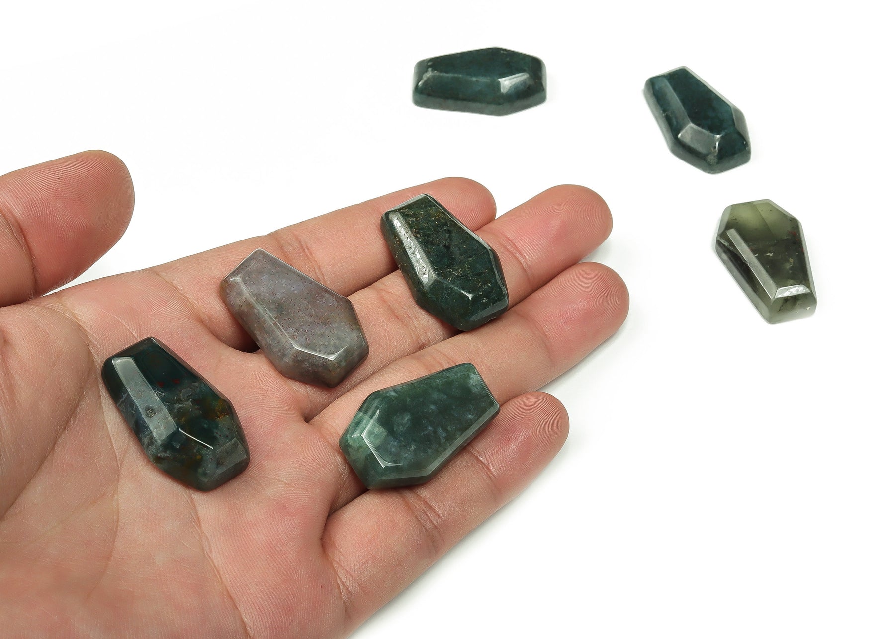 Moss Agate coffin-shaped crystal cabochon carved from gemstone, measuring 30mm, with intricate natural green and brown patterns.