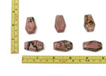 Rhodonite coffin-shaped crystal cabochon with carving, 30mm gemstone by GemstoneGO shown in detailed close-up image.