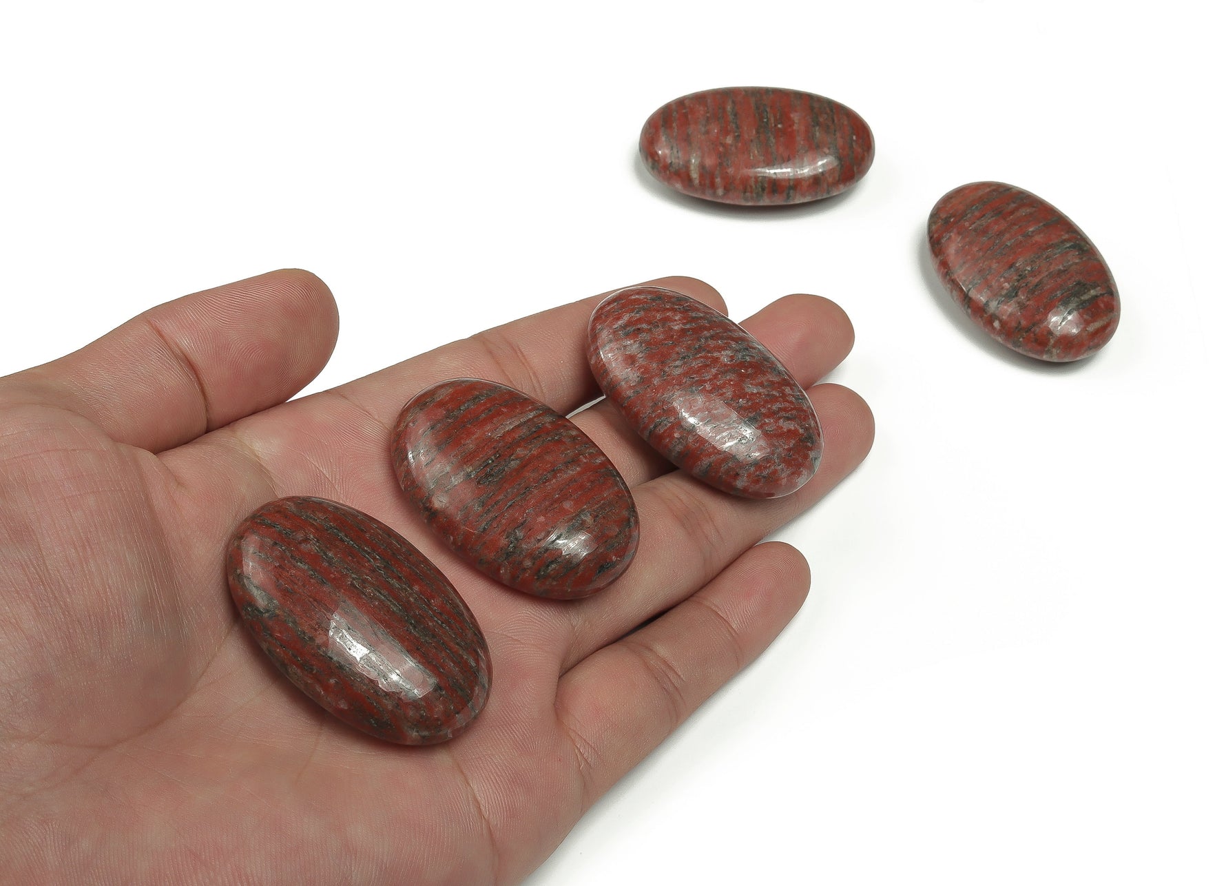 Red Sesame Jasper palm gemstone spa stone, 45x35mm, showcasing smooth, polished red and black patterned jasper for relaxation and healing.