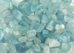 Aquamarine crystal chips, semi-tumbled stones in 6-10mm, from GemstoneGO, shown in a natural arrangement.