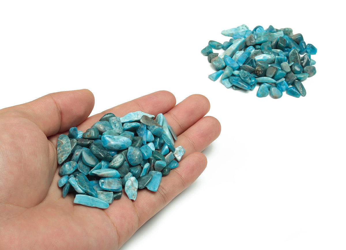 Blue Apatite crystal chips from GemstoneGO, semi-tumbled stones, 7-12mm, shown in a close-up of the vibrant blue crystal chips.