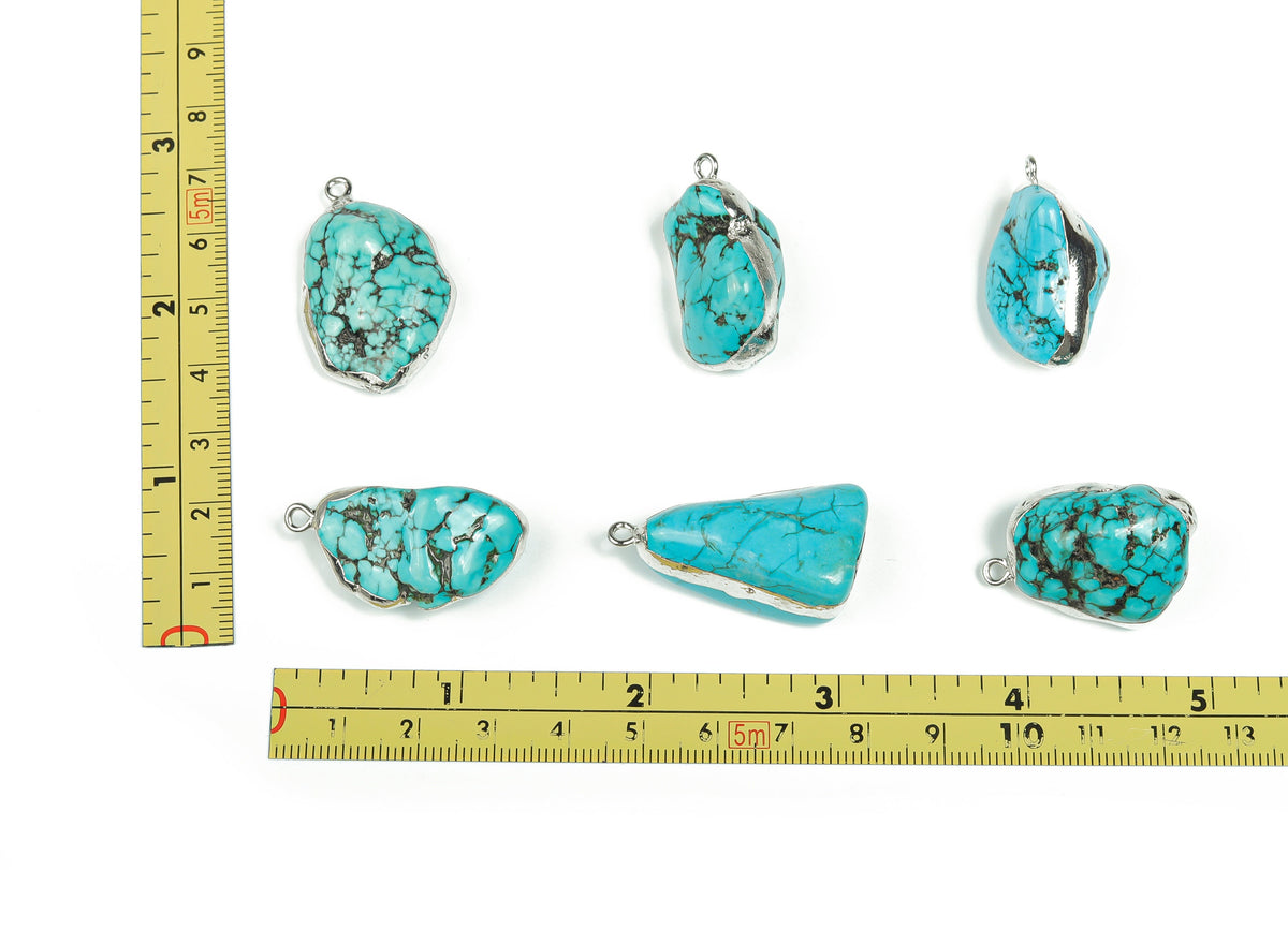 Silver-edged turquoise crystal pendant featuring vibrant turquoise gemstones, showcasing intricate jewelry craftsmanship.