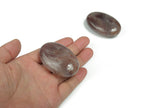 Strawberry Quartz palm gemstone spa stone, 60x40mm, polished gemstone with vibrant pink-red color and smooth surface.
