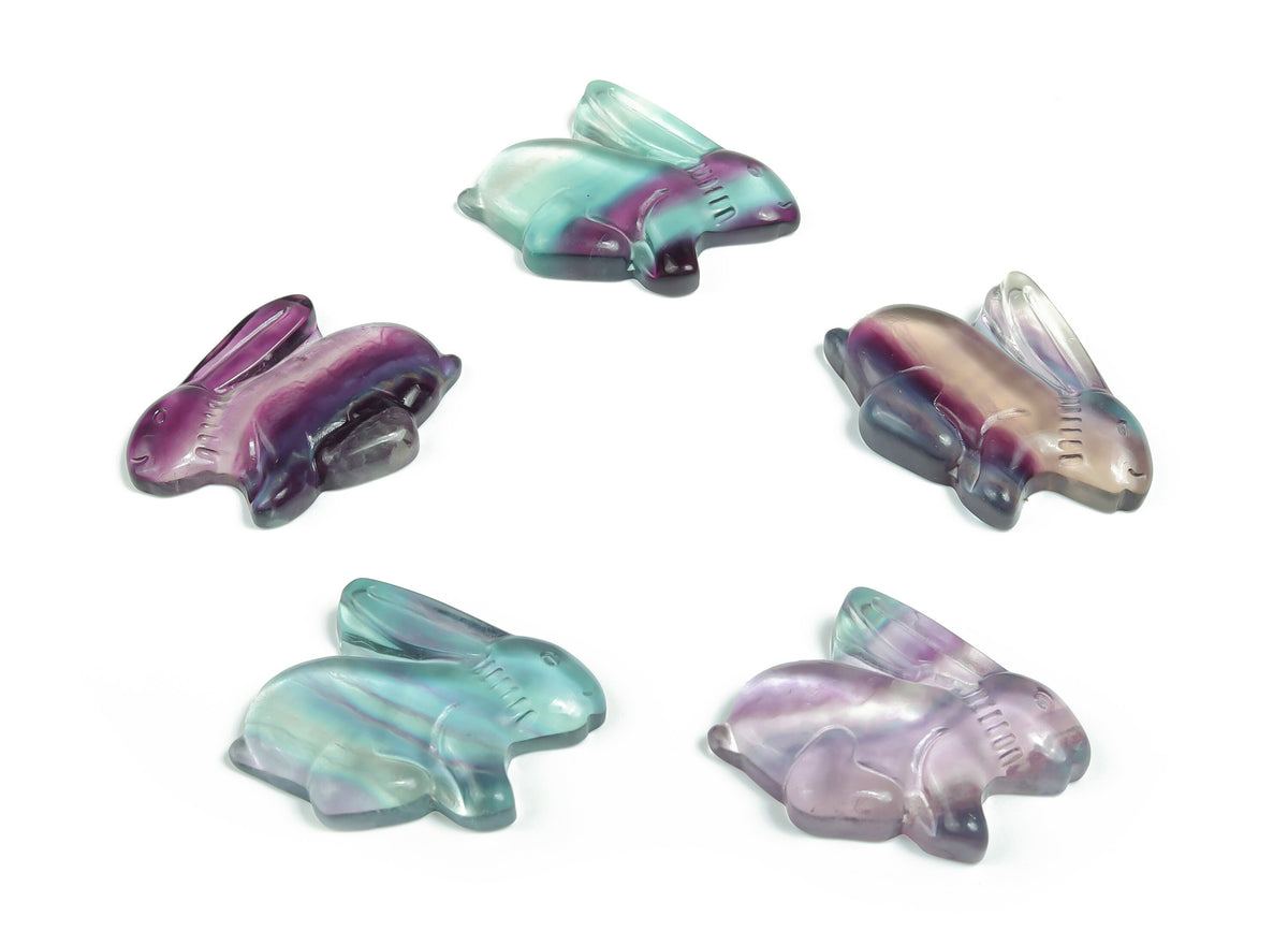 Fluorite rabbit gemstone carving by GemstoneGO, featuring vibrant purple and green hues in a detailed animal sculpture.
