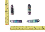 Fluorite bullet-shaped gemstone carving from GemstoneGO, featuring vibrant purple and green hues with polished smooth surface.